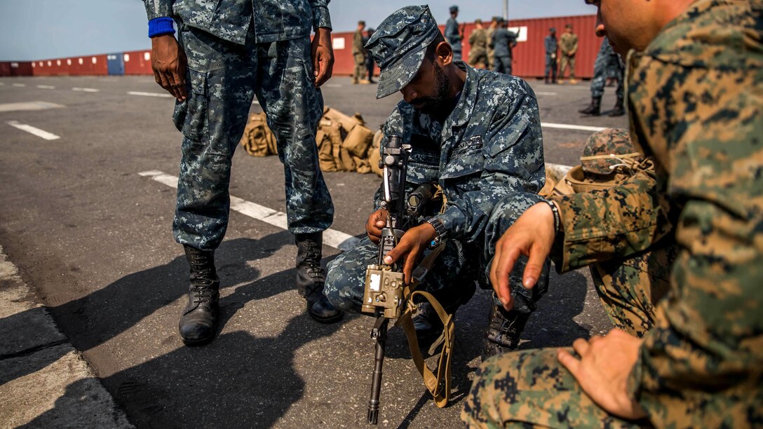 A Sri Lankan Marines disassembles the M4 service rifle alongside U.S. Marines with the 11th Marine Expeditionary Unit, during weapons skills familiarization held at the port of Colombo as part of a theater security cooperation engagement, March 28. USS Comstock and the 11th MEU are in Sri Lanka to exchange expertise on a range of topics as part of ongoing exchanges between the two forces to enhance skills sets and strengthen relations.