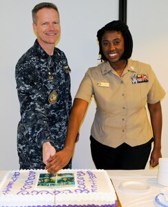Navy Capt. Brent Kelln (left) commanding officer, Navy Medicine Training Support Center, or NMTSC, and Petty Officer 1st Class Joy Lewis, a Hospital Corpsman “A” School instructor cut a ceremonial cake following a Women’s History Month celebration at the Medical Education and Training Campus at Joint Base San Antonio-Fort Sam Houston March 28.