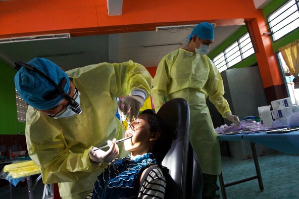 Republic of Singapore Air Force dentists provide treatment for a Thai local during an exercise Cope Tiger 17 (CT17) combined civic action engagement at a school in Nakhon Ratchasima Province, Thailand, March 22, 2017. The combined civic action engagement provided an outlet for the countries participating in CT17 to give back to the community surrounding Korat Royal Thai Air Force Base. Over 1,200 U.S., Thai and Singaporean military members participated in this year's annual multilateral exercise. (U.S. Air Force photo/Staff Sgt. Kamaile Chan)