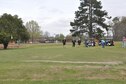 Competitors in the Happy Irby Christmas Fund Golf Tournament gather at the end of the second hole of the Whispering Pines base golf course March 24, 2017, on Columbus Air Force Base, Mississippi. The Happy Christmas Fund Golf Tournament has been played on Columbus AFB for over 20 years. 
