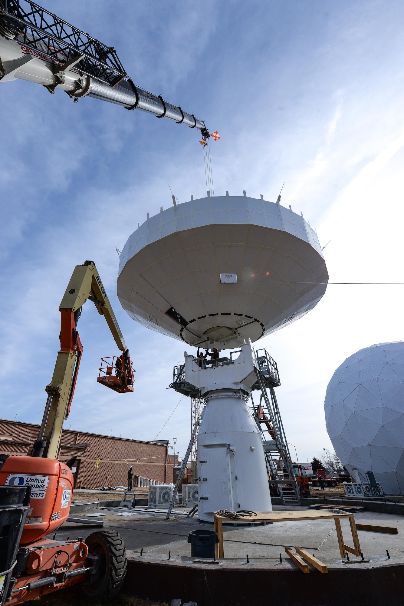 Technicians from the Tobyhanna Army Depot, Pennsylvania secure a communications dish to an Air Force Wideband Enterprise Terminal located at Offutt Air Force Base, Neb., Feb. 14, 2017. AFWET terminals communicate with a variety of satellites and keep military branches and other government agencies connected worldwide. (U.S. Air Force photo by Zachary Hada)
