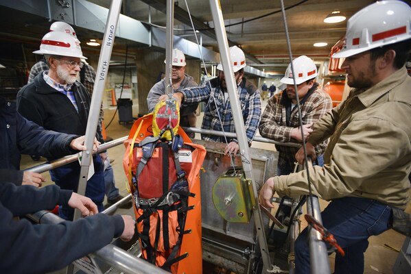 A team Corps employees from various locks and dams throughout the Nashville District hoist a simulated injured worker from a permitted confined space at the Center Hill power plant during a permitted confined space training class March 16, 2017. 