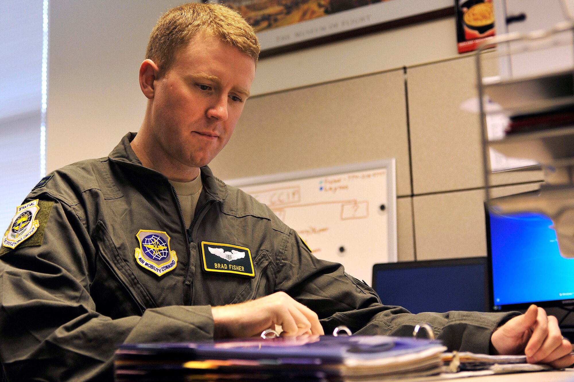Capt. Brad Fisher, 62nd Operations Group commander’s inspection program chief, reviews guidance in his office March 24, 2017 at Joint Base Lewis-McChord, Wash. Fisher was notified of his selection March 22, 2017 to the Olmsted Scholarship Program, a leadership program which aims to produce the next generation of warrior-scholars. (U.S. Air Force photo/Staff Sgt. Whitney Amstutz)