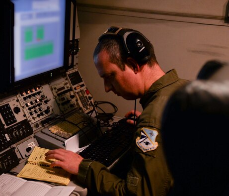 A member of the 963rd Airborne Air Control Squadron works diligently during a training mission, March, 15, 2017, while flying over the Pacific Northwest. The AWACS is an airborne air control squadron capable of providing early warning coverage for the area of responsibility being controlled. (U.S. Air Force photo by Senior Airman Jessica H. Smith/RELEASED) 