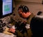 A member of the 963rd Airborne Air Control Squadron works diligently during a training mission, March, 15, 2017, while flying over the Pacific Northwest. The AWACS is an airborne air control squadron capable of providing early warning coverage for the area of responsibility being controlled. (U.S. Air Force photo by Senior Airman Jessica H. Smith/RELEASED) 