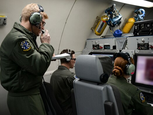 A member with more experience oversees two others during training, March 15, 2017, while flying over the Pacific Northwest. The AWACS worked with F-15s and other aircraft for realistic training scenarios during their time at Mountain Home Air Force Base, Idaho. (U.S. Air force photo by Senior Airman Jessica H. Smith)