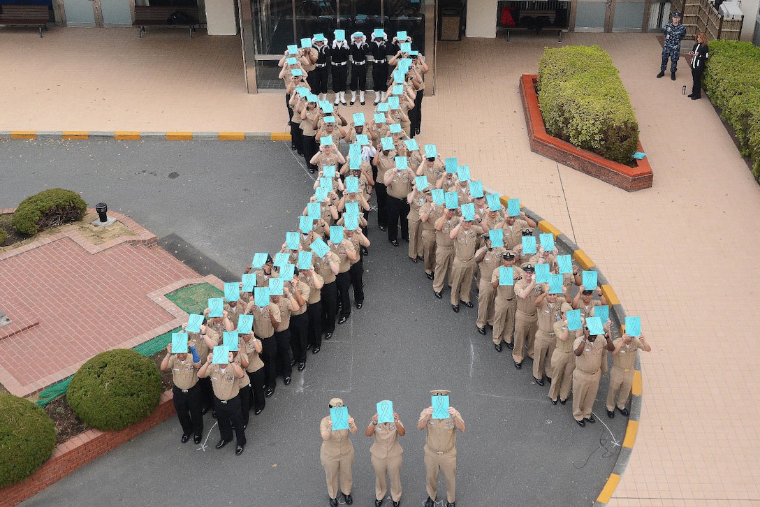Leaders and staff form a human ribbon to mark Sexual Assault Awareness and Prevention Month at U.S. Naval Hospital Yokosuka, Japan, March 31, 2017. Navy photo by Greg Mitchell