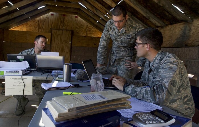Contracting personnel from multiple bases discuss options for contracts after meeting with simulated vendors during a training exercise on Nellis Air Force Base, Nev., March 16, 2017. The training exercise included one day in the classroom, and one full day in the field, performing hands-on scenarios tailored to develop the skills and techniques necessary for setting up in remote, undeveloped locations. (U.S. Air Force photo by Airman 1st Class Kevin Tanenbaum/Released)