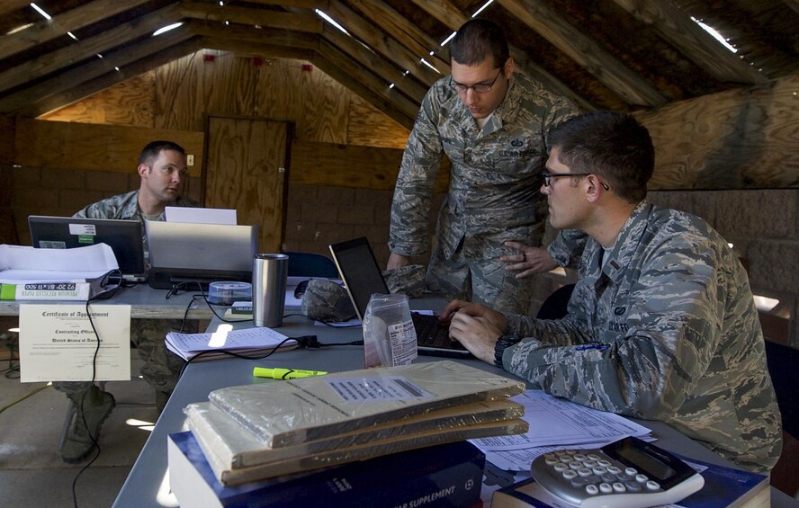 Contracting personnel from multiple bases discuss options for contracts after meeting with simulated vendors during a training exercise on Nellis Air Force Base, Nev., March 16, 2017. The training exercise included one day in the classroom, and one full day in the field, performing hands-on scenarios tailored to develop the skills and techniques necessary for setting up in remote, undeveloped locations. (U.S. Air Force photo by Airman 1st Class Kevin Tanenbaum/Released)