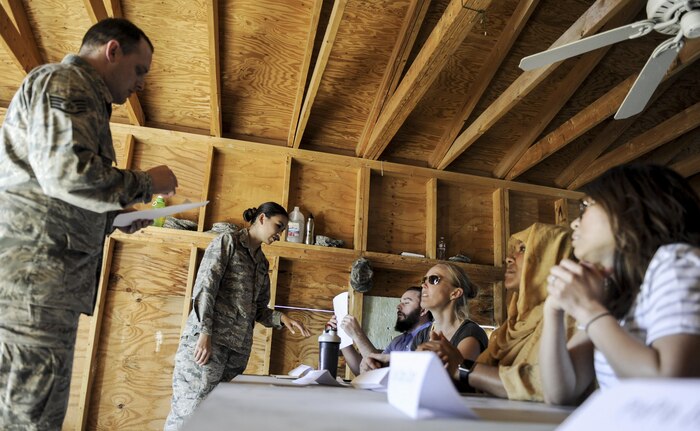 Simulated vendors attempt to convince a team of U.S. Air Force contracting officer’s award contracts during a 99th Contracting Squadron training exercise on Nellis Air Force Base, Nev., March 16, 2017. The exercise simulated a unit arriving in a deployed environment for the first time. (U.S. Air Force photo by Airman 1st Class Kevin Tanenbaum/Released)