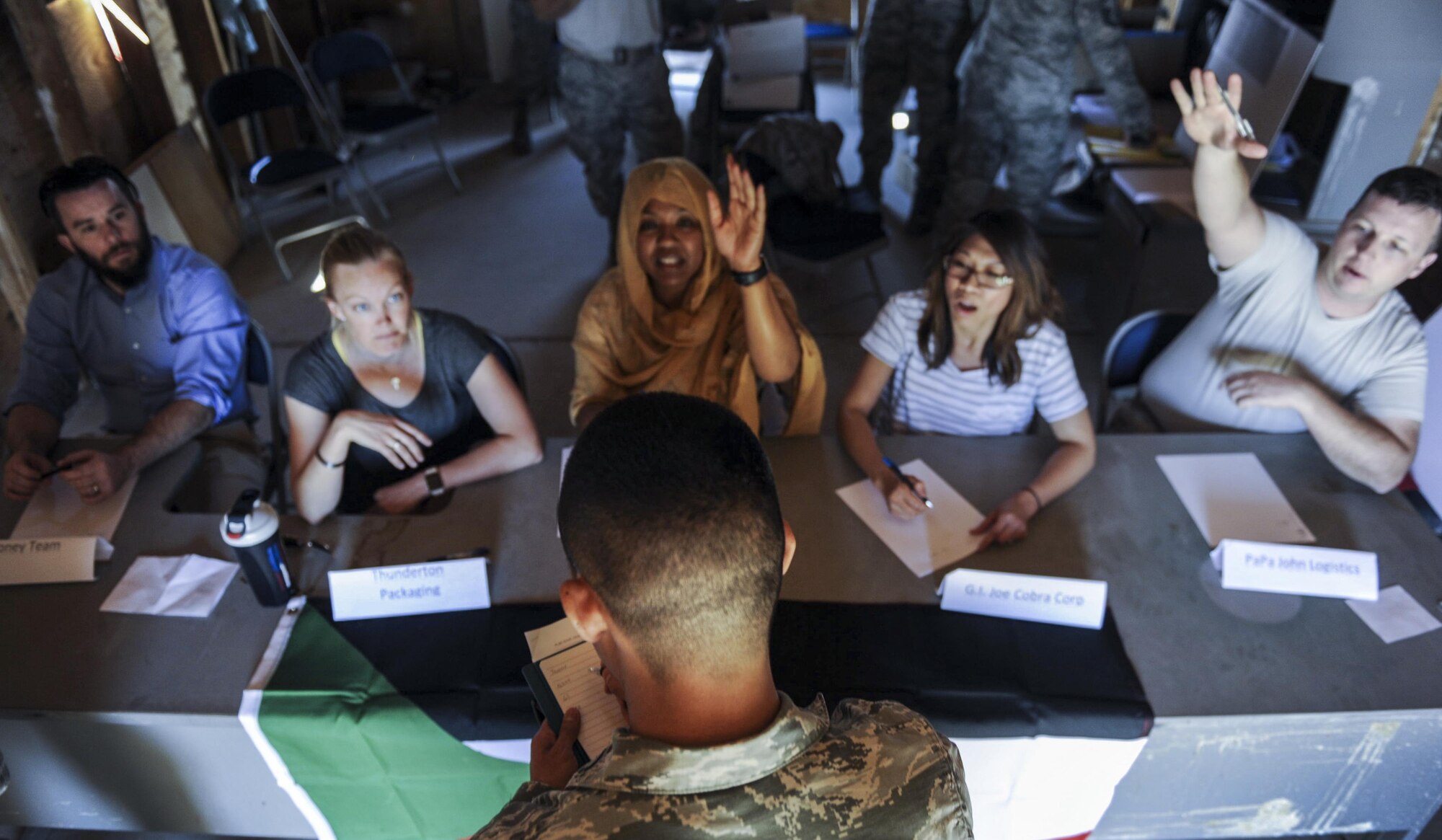 A contracting officer writes down what each of the simulated vendors can provide during a 99th Contracting Squadron training exercise on Nellis Air Force Base, Nev., March 16, 2017. Contracting Squadrons execute central acquisition and contract performance management programs on bases and in deployed environments. (U.S. Air Force photo by Airman 1st Class Kevin Tanenbaum/Released)