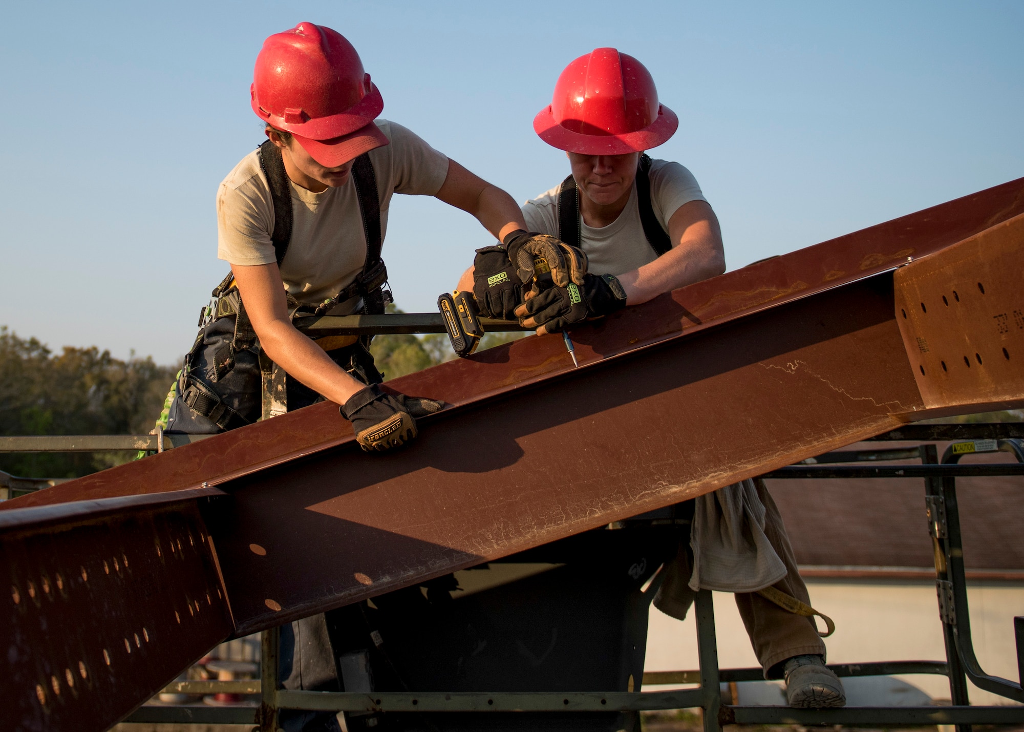Senior Airman Paige Rodgers and Staff Sgt. Keny Drescher-Brown, 823rd Red Horse Squadron, position and drill a beam into place March 23 during a construction project at Eglin Air Force Base, Fla. The 96th Civil Engineer Group’s open air pavilion is one of many troop training projects the 823rd RHS will complete for the Department of Defense, the Air Force and the local community to maintain their skills until the next deployment. (U.S. Air Force photo/Ilka Cole)