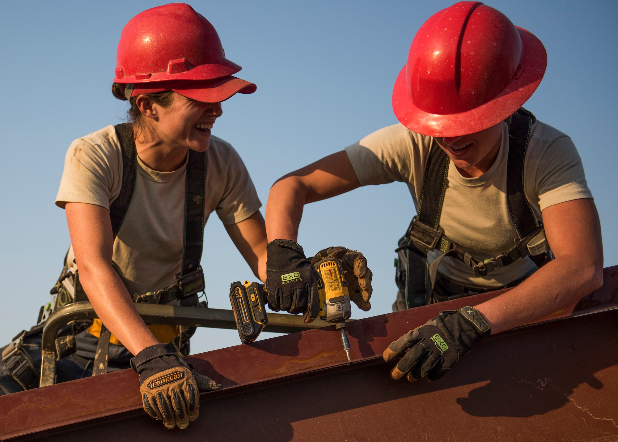Senior Airman Paige Rodgers and Staff Sgt. Keny Drescher-Brown, 823rd Red Horse Squadron, share a moment of levity while they position and drill a beam into place March 23 during a construction project at Eglin Air Force Base, Fla. The 96th Civil Engineer Group’s open air pavilion is one of many troop training projects the 823rd RHS will complete for the Department of Defense, the Air Force and the local community to maintain their skills until the next deployment. (U.S. Air Force photo/Ilka Cole)