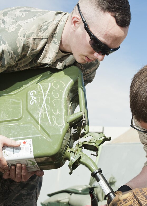 Airman 1st Class Heath Rauch, 91st Missile Maintenance Squadron electromechanical team technician, refuels a water-pump near Bowbells, N.D., March 29, 2017. Rauch was a part of a two-man team responsible for relocating flood-water away from critical assets at the launch facility. (U.S Air Force photo/Senior Airman J.T. Armstrong)