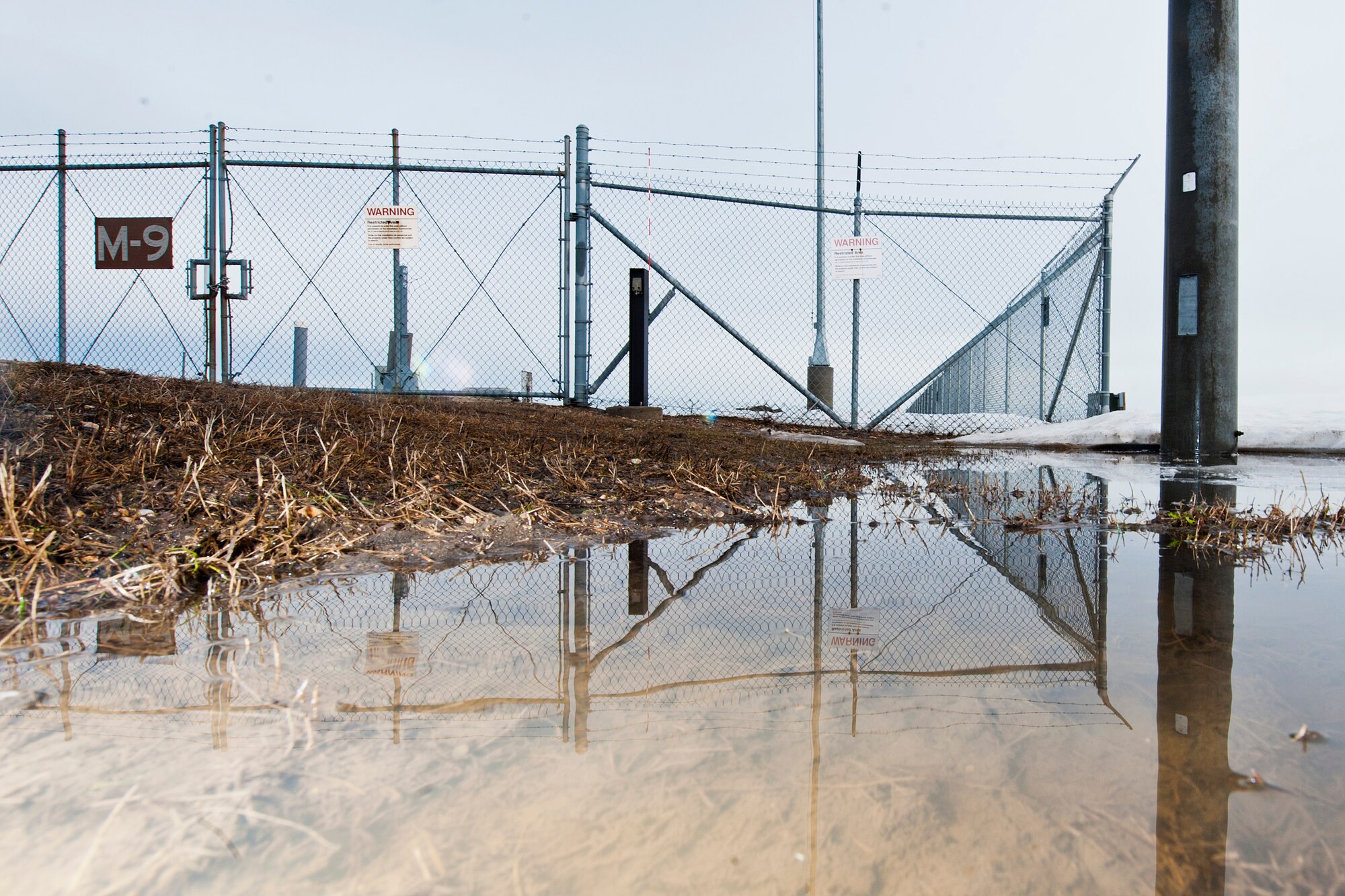 Water collects around a 91st Missile Wing launch facility in northern N.D., March 29, 2016. After accessing the site, electromechanical team technicians measured water levels and determined where to move the excess water. (U.S Air Force photo/Senior Airman J.T. Armstrong)