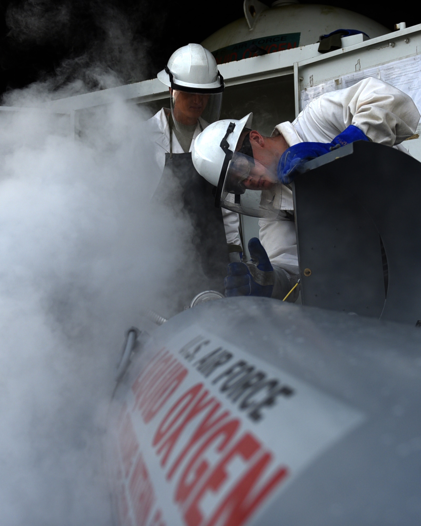 U.S. Air Force Senior Airman Jesse Frady and U.S. Air Force Senior Airman Richard Hayes, 19th Logistics Readiness Squadron fuel cryogenics journeymen, fill a 50-gallon container with liquid oxygen, or LOX, March, 27, 2017, at Little Rock Air Force Base, Ark. Frady and Hayes supply C-130J pilots with fresh oxygen so they can perform high altitude air drops, air medical evacuations and with stand high altitude cabin decompressions. (U.S. Air Force photo by Airman 1st Class Kevin Sommer Giron)