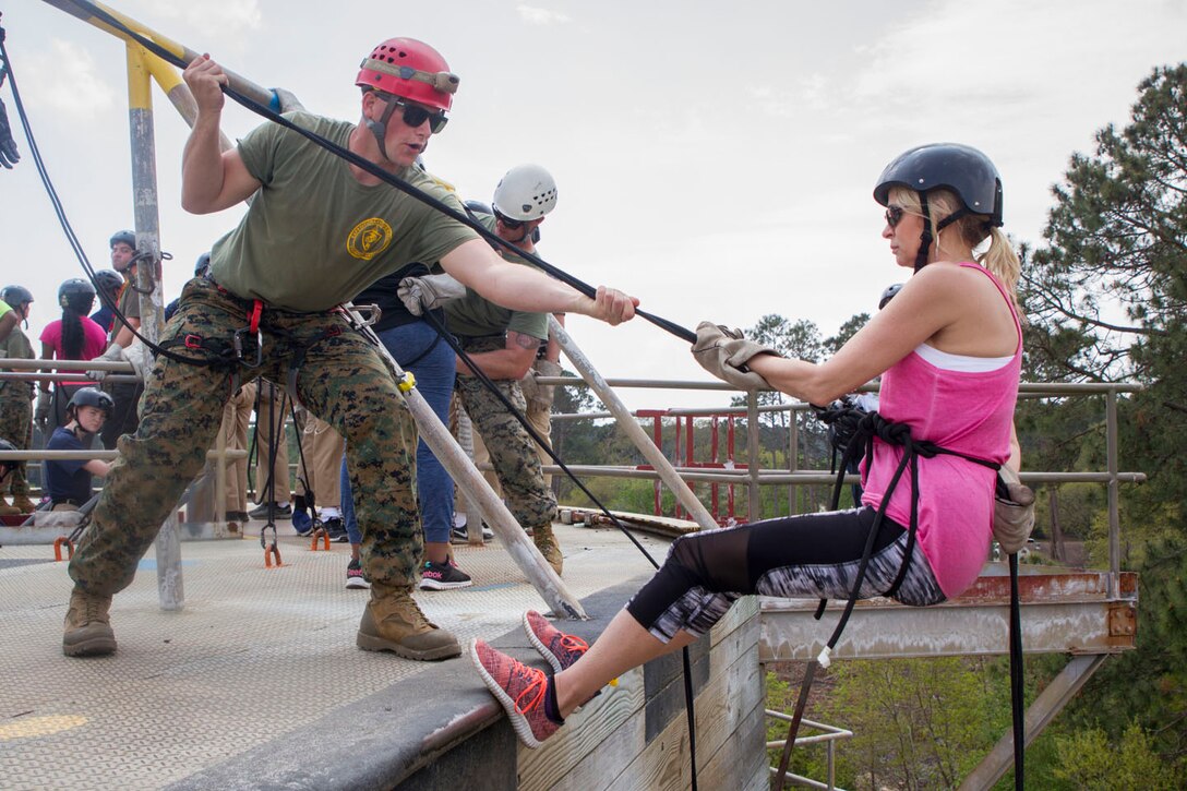 Pamela Lacombe, a counselor at Delhi Charter High School in Delhi, Louisiana, descends from the rappel tower Mar. 30, 2017, during the Recruiting Stations Baton Rouge and Jacksonville Educators Workshop aboard Marine Corps Recruit Depot Parris Island, South Carolina. The Educators come from both Recruiting Station Baton Rouge and Jacksonville to experience the Educators Workshop. The workshop allows educators to have an inside look at educational benefits and career opportunities in the Marine Corps to better inform their students.(Official Marine Corps photo by Cpl. Adeline N. Smith/Released)