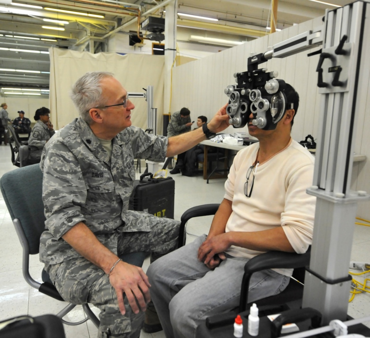 Air Force Lt. Col. Mark Davis with the 147th Medical Group adjusts a manual phoropter in order to find the correct prescription lenses for a patient during Arctic Care 2017 in Kodiak, Alaska, March 28, 2017. The Air Force Reserve-led medical readiness exercise gives service members an opportunity to train on deployable medical equipment while serving the citizens of Kodiak Island Alaska. Air Force photo by Master Sgt. Luke Johnson