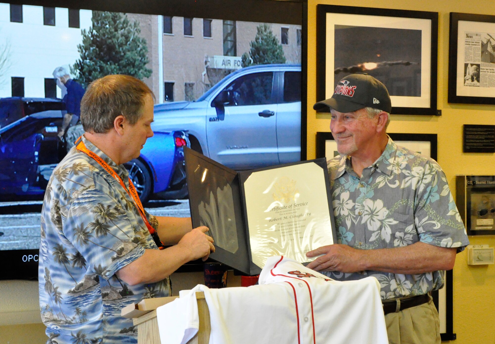 Keith Shrock, left, Air Force Research Laboratory Directed Energy Directorate Mission Planning and Support division chief, presents Robert Clougherty with a certificate of service at Clougherty’s retirement event held earlier this month at the AFRL Heritage Annex on Kirtland Air Force Base.