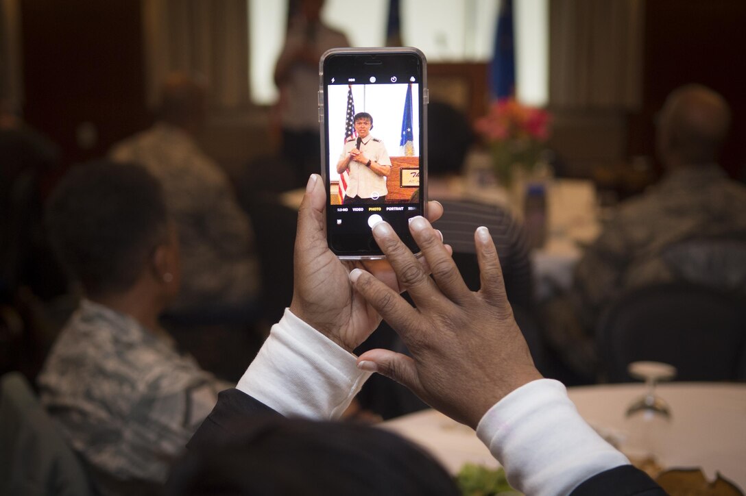 A guest takes a picture of Lt. Gen. Stayce Harris, assistant vice chief of staff, Headquarters U.S. Air Force, Washington, D.C., speaking at Joint Base Andrews, Md., for Women’s History Month, March 31, 2017. Harris was the third and final speaker of a series commemorating Women’s History Month. (U.S. Air Force photo by Senior Airman Mariah Haddenham)