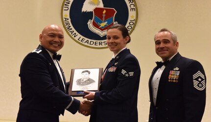 Col. Jimmy Canlas, left, 437th Airlift Wing commander, and Chief Master Sgt. Kristopher Berg, right, 437th AW command chief, congratulate Senior Airman Andrea Jansen 16th Airlift Squadron loadmaster, for earning the John L. Levitow Award during the class 17-C Airman Leadership School Graduation ceremony March 30, 2017, at Joint Base Charleston, South Carolina. The Levitow Award is the highest honor awarded to an ALS graduate and is given to the Airman who displays the highest level of leadership qualities. ALS is a five-week course encompassing lessons in the principles of supervision and management, the importance of communication and military professionalism. 