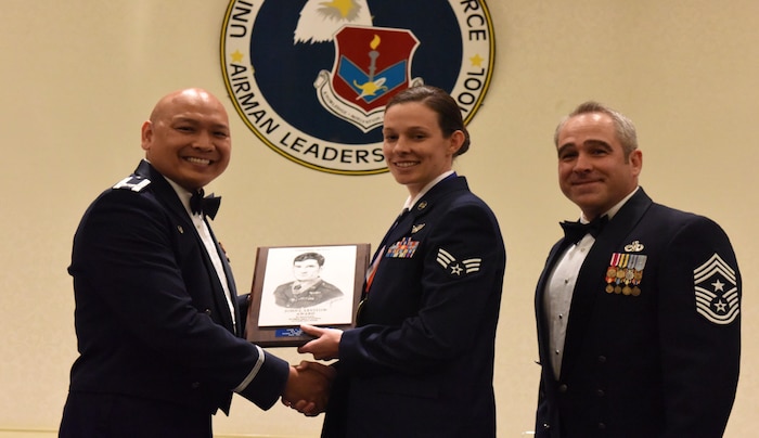 Col. Jimmy Canlas, left, 437th Airlift Wing commander, and Chief Master Sgt. Kristopher Berg, right, 437th AW command chief, congratulate Senior Airman Andrea Jansen 16th Airlift Squadron loadmaster, for earning the John L. Levitow Award during the class 17-C Airman Leadership School Graduation ceremony March 30, 2017, at Joint Base Charleston, South Carolina. The Levitow Award is the highest honor awarded to an ALS graduate and is given to the Airman who displays the highest level of leadership qualities. ALS is a five-week course encompassing lessons in the principles of supervision and management, the importance of communication and military professionalism. 
