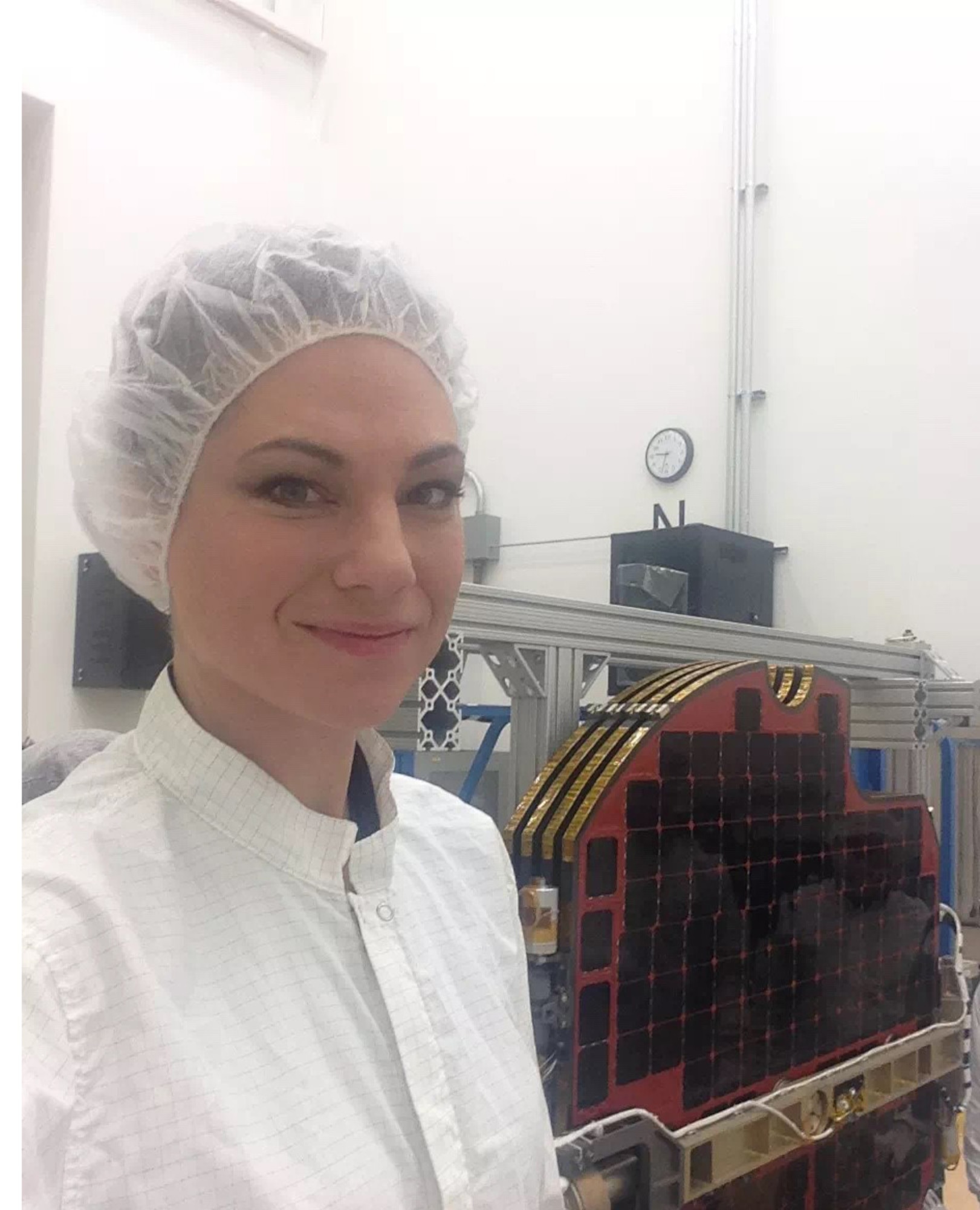 Millay Petersen, Air Force Research Laboratory's Space Vehicles Directorate engineer, assists with a solar array deployment test to prove that the solar array hinges and explosive bolt release mechanisms will function correctly when the satellite unfolds the solar array in space.
