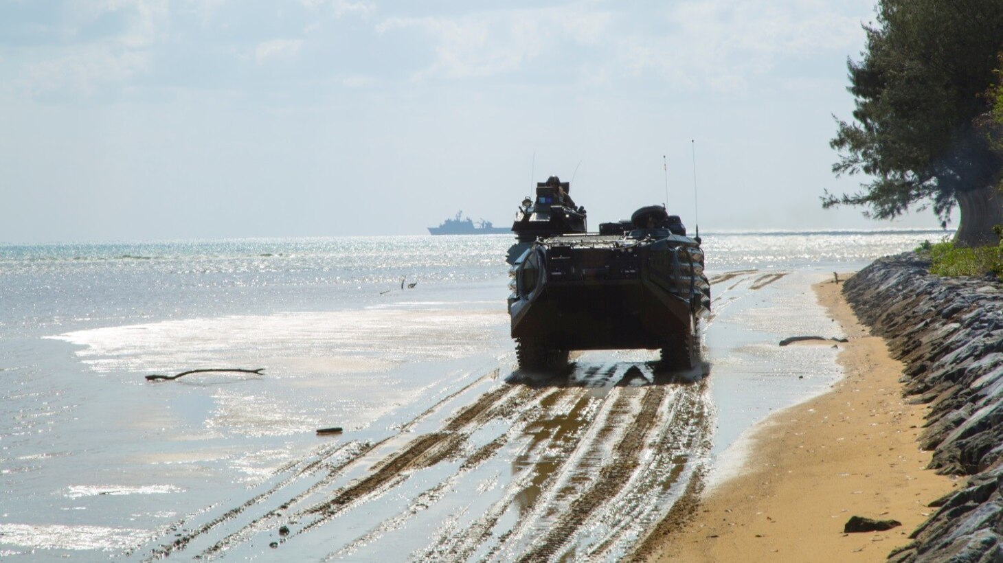An assault amphibious vehicle maneuvers its way across a beach during an amphibious assault exercise March 15 aboard Kushi Crossing, Okinawa, Japan. Waves of AAVs loaded with 31st Marine Expeditionary Unit Marines disembarked the USS Bonhomme Richard and stormed the beach during the exercise. Amphibious operations training is one of the many scenarios the 31st MEU conducts during their 2017 spring deployment. 