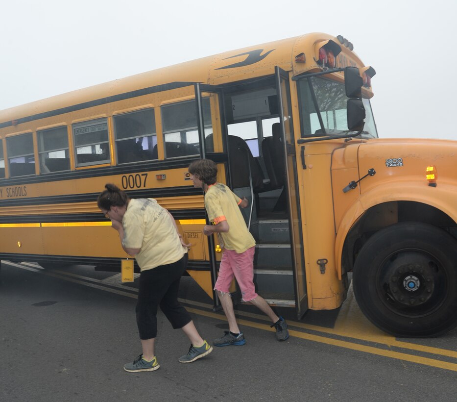 Role players disembark a school bus during a simulated hazardous material release while participating in Exercise Vigilant Guard aboard Marine Corps Logistics Base Albany, March 29. 