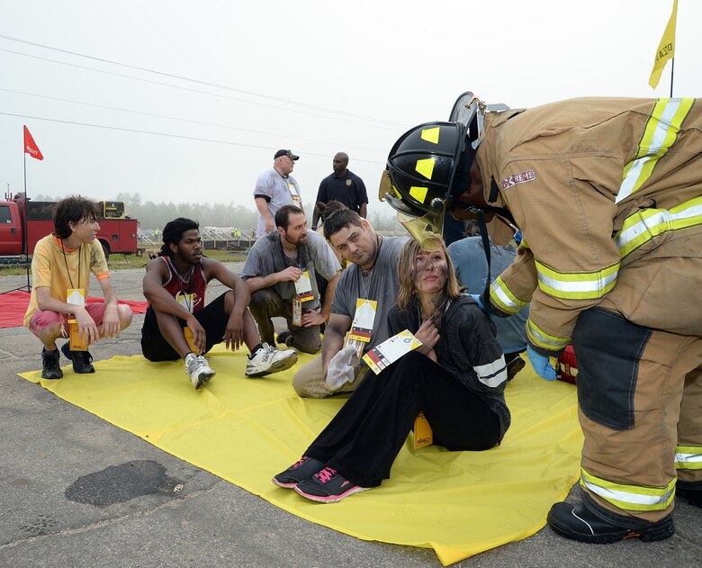 Role players receive an evaluation from a Marine Corps Logistics Base Albany firefighter during a simulated hazardous material release while participating in Exercise Vigilant Guard aboard the installation, March 29. 
