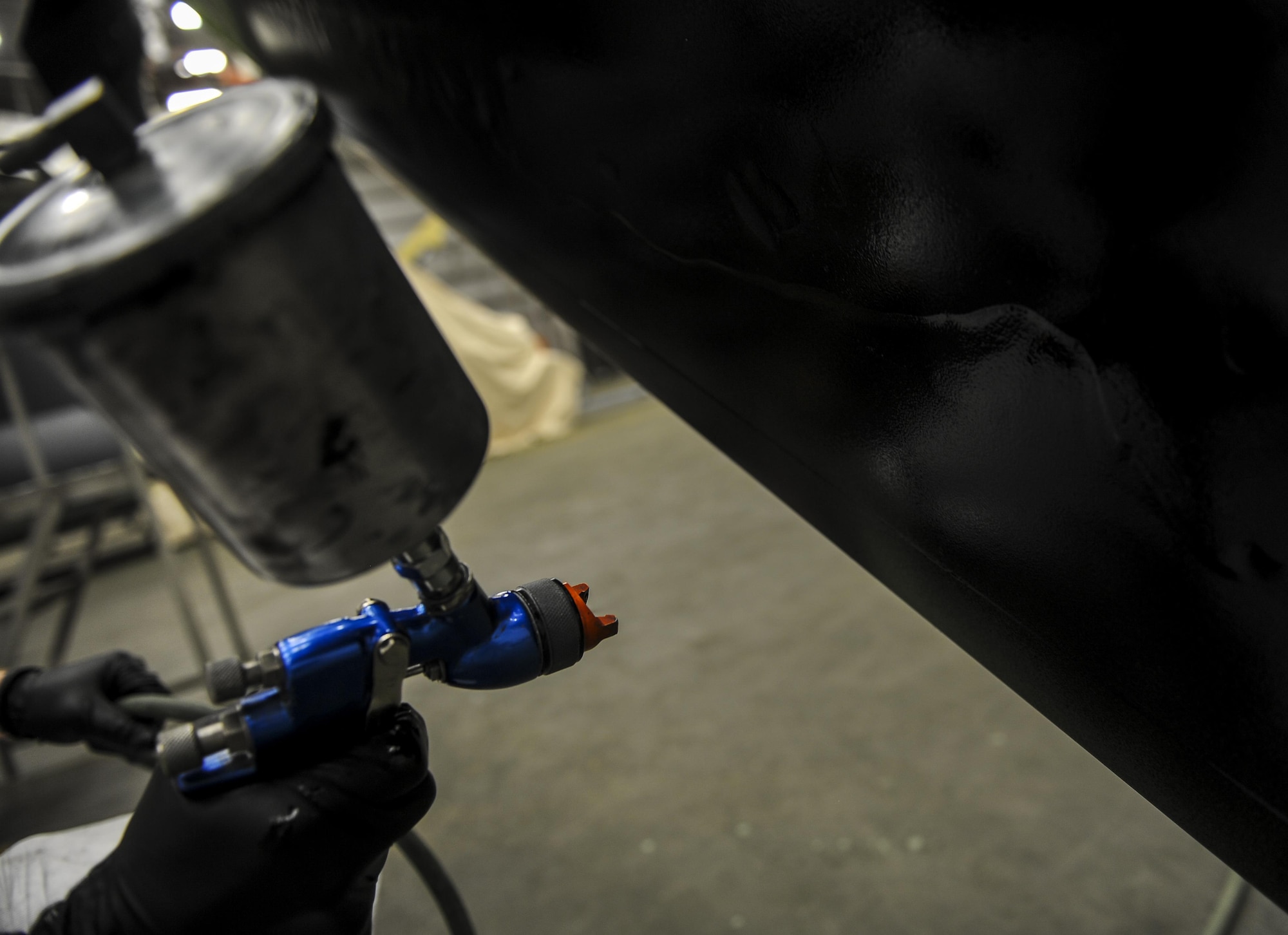 Airman 1st Class Ethan Short, an aircraft structural maintainer with the 1st Special Operations Maintenance Squadron, sprays rain erosion prevention paint onto a CV-22 Osprey at Hurlburt Field, Fla., March 29 2017. Rain erosion prevention paint gives the propellers an extra layer of protection against environmental exposure. (U.S. Air Force photo by Airman 1st Class Isaac O. Guest IV)