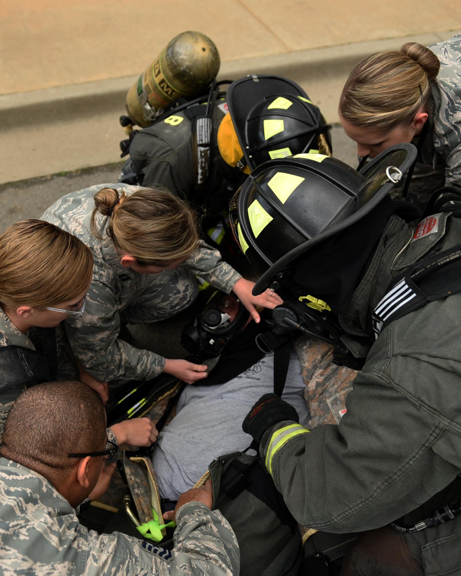 Members of the 19th Aerospace Medicine Squadron check vitals on U.S. Air Force Michael Leger, 19th Civil Engineer Squadron Fire Department firefighter, during a major accident response inspection March 30, 2017, at the Jacksonville Fire Department Training Center, Ark. The 19th AMDS response team was responsible for stabilizing patients, checking their vitals, and coordinating transfers to the emergency room. (U.S. Air Force photo by Airman 1st Class Kevin Sommer Giron)