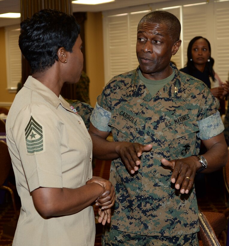 Col. James C. Carroll III, commanding officer, Marine Corps Logistics Base Albany, speaks to guest speaker, Sgt. Maj. Lanette Wright, sergeant major, 4th Marine Logistics Group, after a Women’s History Month luncheon at Marine Corps Logistics Base Albany's Town and Country Restaurant Grand Ballroom, March 30. The event, themed, “Honoring Trailblazing Women in Labor and Business,” was held to recognize the contributions and accomplishments women have made throughout the years.