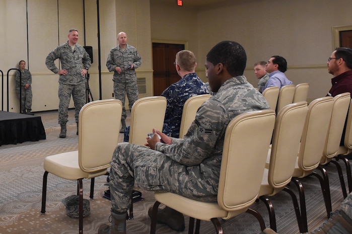 Col. Robert Lyman, left, 628th Air Base Wing commander, left, and Chief Master Sgt. Todd Cole, right, 628th ABW command chief, right, answer questions asked by Airmen through their phones during a commander’s call at Joint Base Charleston, South Carolina, March 29, 2017. Airmen asked questions regarding current JB Charleston and Air Force news.  Highlights include the new civilian rating program that takes effect on April 1, 2017 as well as a reminder from the JB Charleston legal office that the last day to do your taxes is April 18, 2017.