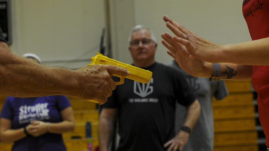 Michael “Moose” Moore, founder of The Vigilance Group, demonstrates defensive techniques used to get away from a perpetrator with a handgun to a group of Air Commando spouses at Hurlburt Field, Fla., March 31, 2017. This training provides techniques to avoid danger and actions to take if violence is not preventable. (U.S. Air Force photo by Airman 1st Class Isaac O. Guest IV)