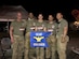 (Left to Right) U.S. Air Force Reservists, Master Sgt. John Herrick, 39, who has completed three other marathons; Staff Sgt. Tyrone Hawkins, 47, an avid cyclist; 2nd Lt. Amber Schoenberger, a direct descendent of a Bataan Death March survivor; Tech. Sgt. Delbert Templeton, 36, a prior Marine; and Tech. Sgt. Trevor Petersma, 39, who completed the Air Force half marathon while deployed in Iraq in 2008, all members of the 610th Command and Control Squadron, pose behind their unit guidon after completing the Bataan Memorial Death March Marathon March 19 at White Sands Missile Range, NM. (Courtesy photo)