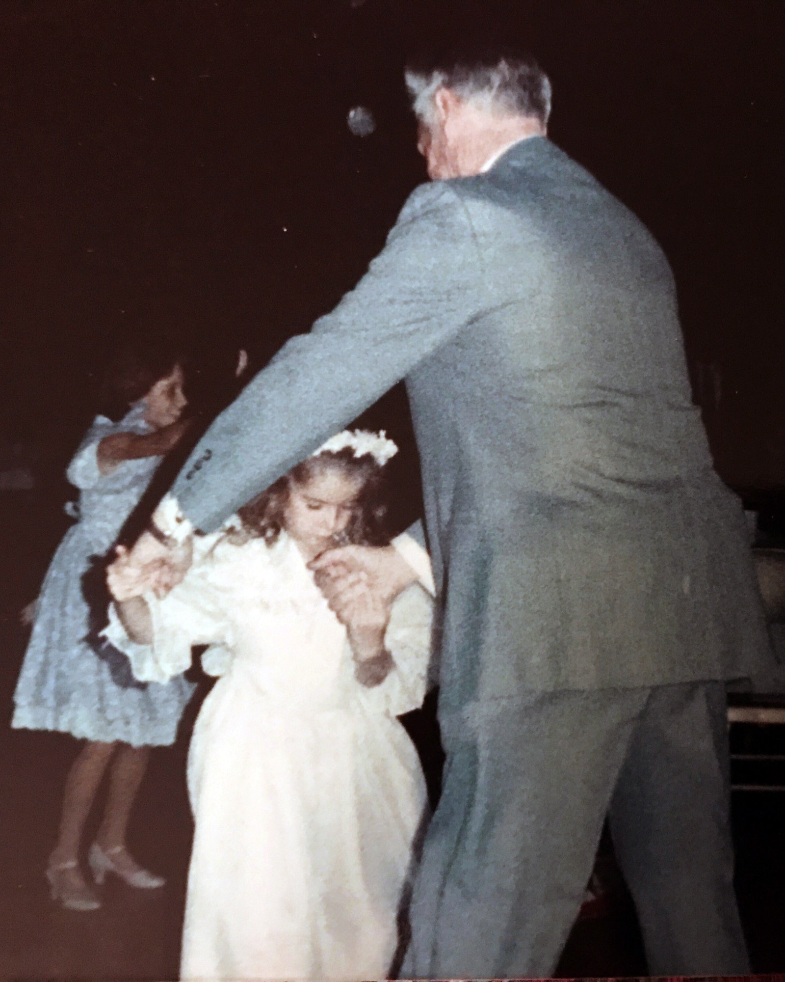 Amber Schoenberger, now a lieutenant in the Air Force Reserve, dances on her granddaddy's feet nearly 30 years ago. U.S. Army Air Forces Cpl Willard Edwin Howard (1921-2009) was a survivor of the 1942 Bataan Death March, and Schoenberger completed a memorial marathon March 19 at White Sands Missile Range, NM, in his honor. (Courtesy photo)