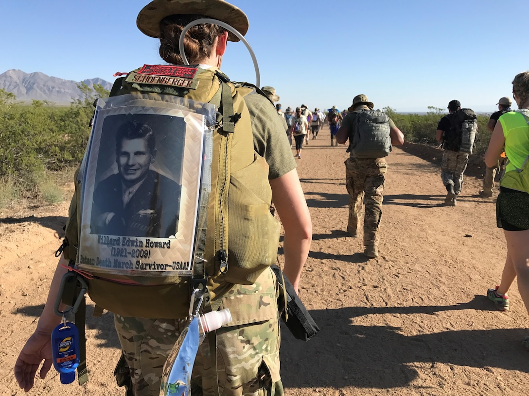 For Air Force 2nd Lt. Amber Schoenberger marches in the Bataan Memorial Death March Marathon March 19 at White Sands Missile Range, NM, in honor of her grandfather (pictured on her backpack), U.S. Army Air Forces Cpl Willard Edwin Howard (1921-2009), who survived the grueling march in 1942. (Courtesy photo) 