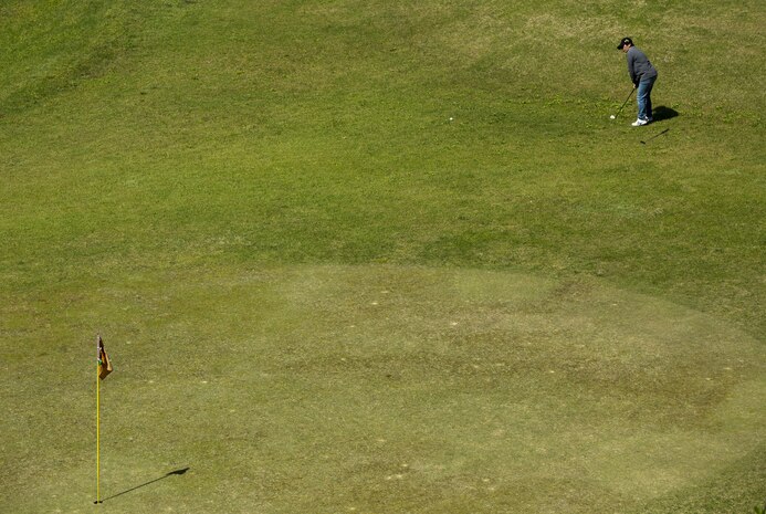 A participant in the 4th Annual Active-Duty Fund Drive in support of the Navy-Marine Corps Relief Society Golf Tournament chips a ball toward the hole at the Iwakuni Country Club in Iwakuni City, Japan, April 28, 2017. The tournament raised funds for the NMCRS, which provides emergency financial assistance to active-duty and retired Navy and Marine Corps personnel and their families. (U.S. Marine Corps photo by Pfc. Stephen Campbell)