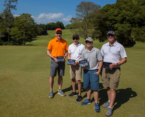 Members of the Life Saving Mulligans team who participated in the 4th Annual Active-Duty Fund Drive in support of the Navy-Marine Corps Relief Society Golf Tournament pose for a photo at the Iwakuni Country Club in Iwakuni City, Japan, April 28, 2017. The Life Saving Mulligans won the tournament and were each awarded a box of Titleist Pro V1 Golf Balls. The tournament raised funds for the NMCRS, which provides emergency financial assistance to active-duty and retired Navy and Marine Corps personnel and their families. (U.S. Marine Corps photo by Pfc. Stephen Campbell)