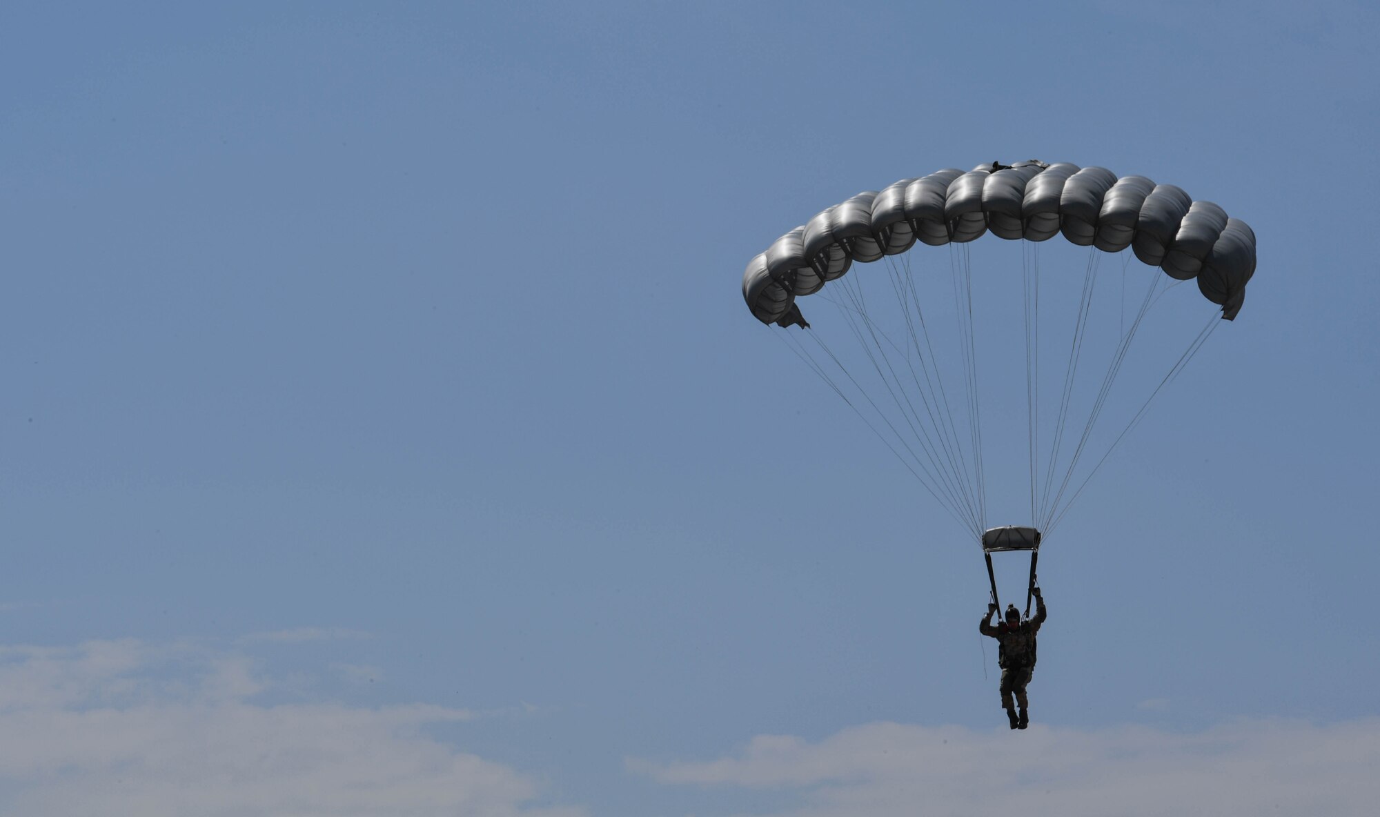 A Greek paratrooper descends to the ground after conducting a military free-fall jump out of a U.S. Air Force C-130J Super Hercules during Exercise Stolen Cerberus IV above Megara, Greece, April 22, 2017. The U.S. Air Force and Army have worked alongside the Hellenic air force to perform personnel and cargo drops throughout the exercise. These interoperability air exercises help to maintain joint readiness. (U.S Air Force photo by Senior Airman Tryphena Mayhugh)
