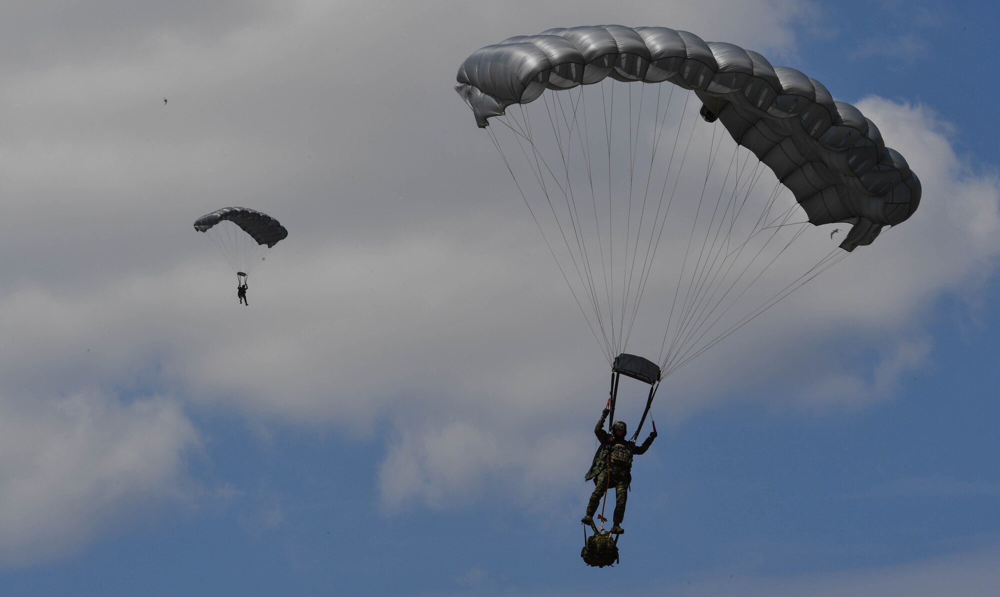 Two Greek paratroopers descend to the ground after conducting a military free-fall jump out of a U.S. Air Force C-130J Super Hercules during Exercise Stolen Cerberus IV above Megara, Greece, April 22, 2017. The U.S. Air Force and Army have worked alongside the Hellenic air force to perform personnel and cargo drops throughout the exercise. The purpose of the exercise was to train U.S. and Greek forces while strengthening the partnership between two NATO allies. (U.S Air Force photo by Senior Airman Tryphena Mayhugh)