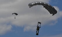 Two Greek paratroopers descend to the ground after conducting a military free-fall jump out of a U.S. Air Force C-130J Super Hercules during Exercise Stolen Cerberus IV above Megara, Greece, April 22, 2017. The U.S. Air Force and Army have worked alongside the Hellenic air force to perform personnel and cargo drops throughout the exercise. The purpose of the exercise was to train U.S. and Greek forces while strengthening the partnership between two NATO allies. (U.S Air Force photo by Senior Airman Tryphena Mayhugh)