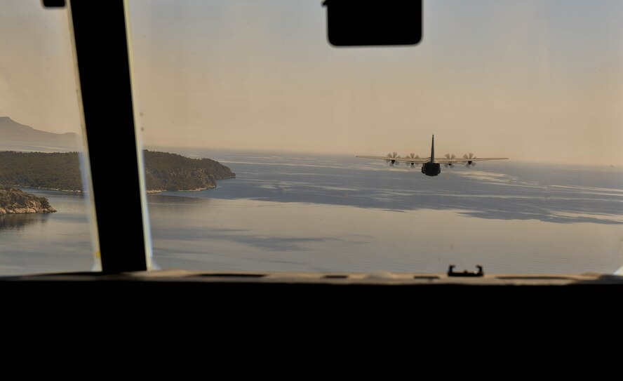 A U.S. Air Force C-130J Super Hercules flies over the Greek coastline during Exercise Stolen Cerberus IV near Elefsis Air Base, Greece, April 26, 2017. Approximately 80 paratroopers exited from two C-130s for static-line and military free fall jumps. The purpose of the exercise was to train U.S. and Greek forces while strengthening the partnership between two NATO allies. (U.S Air Force photo by Senior Airman Tryphena Mayhugh)