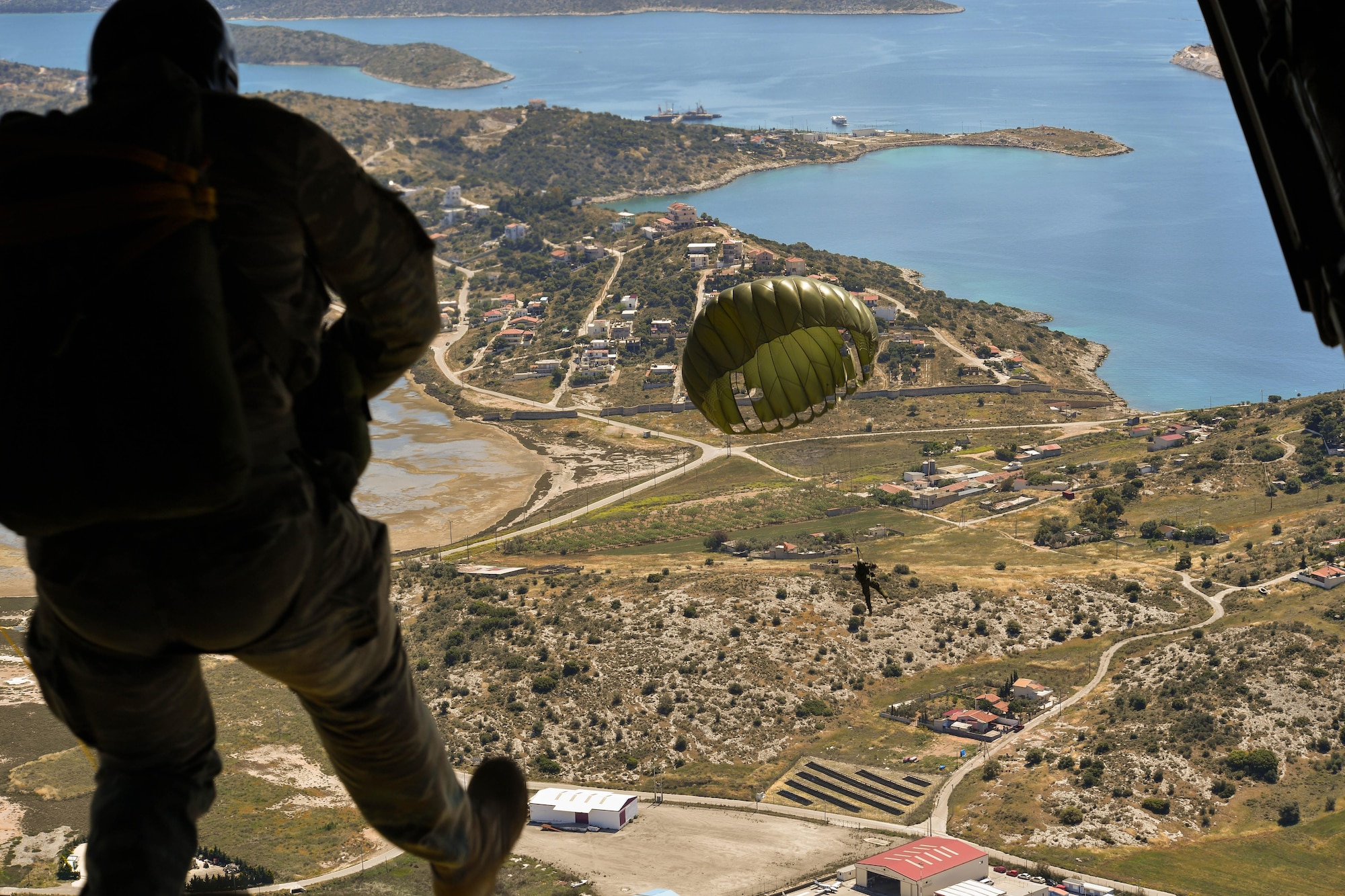 A Greek paratrooper conducts a military free-fall jump from a U.S. Air Force C-130J Super Hercules during Exercise Stolen Cerberus IV above Megara, Greece, April 26, 2017. Throughout the exercise, 265 Greek paratroopers conducted static-line and military free-fall jumps form U.S. aircrafts. Combined exercises such as these enhance the interoperability capabilities and skills among allied and partner armed forces. (U.S Air Force photo by Senior Airman Tryphena Mayhugh)