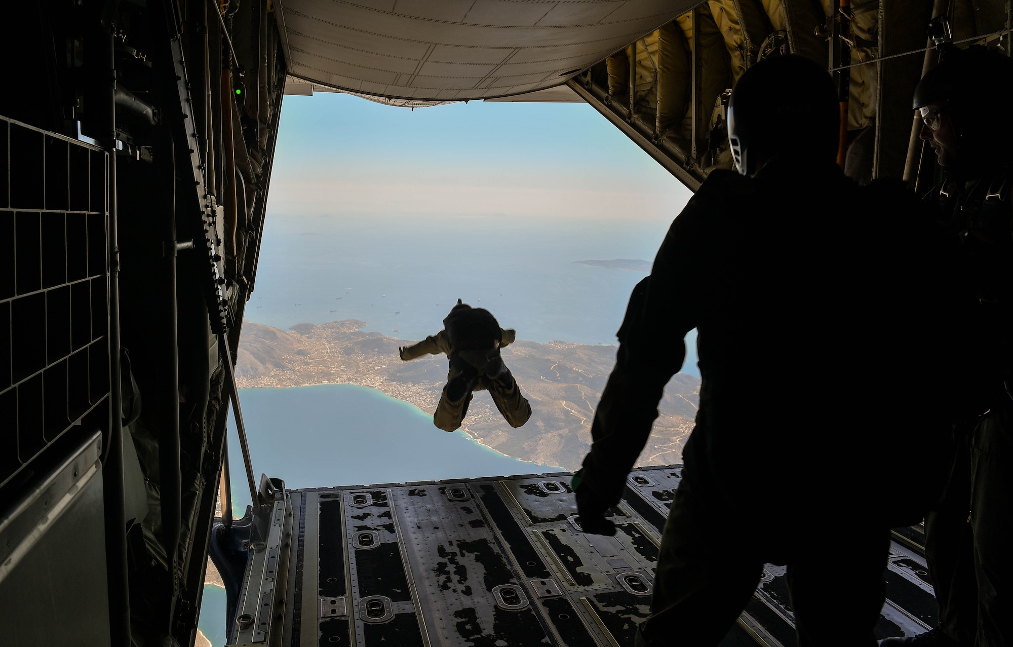 A Greek paratrooper conducts a military free-fall jump from a U.S. Air Force C-130J Super Hercules during Exercise Stolen Cerberus IV above Megara, Greece, April 27, 2017. U.S. Air Force and Army service members trained alongside the Hellenic air force in personnel and cargo drops during the fourth iteration of the exercise in Greece. (U.S Air Force photo by Senior Airman Tryphena Mayhugh)