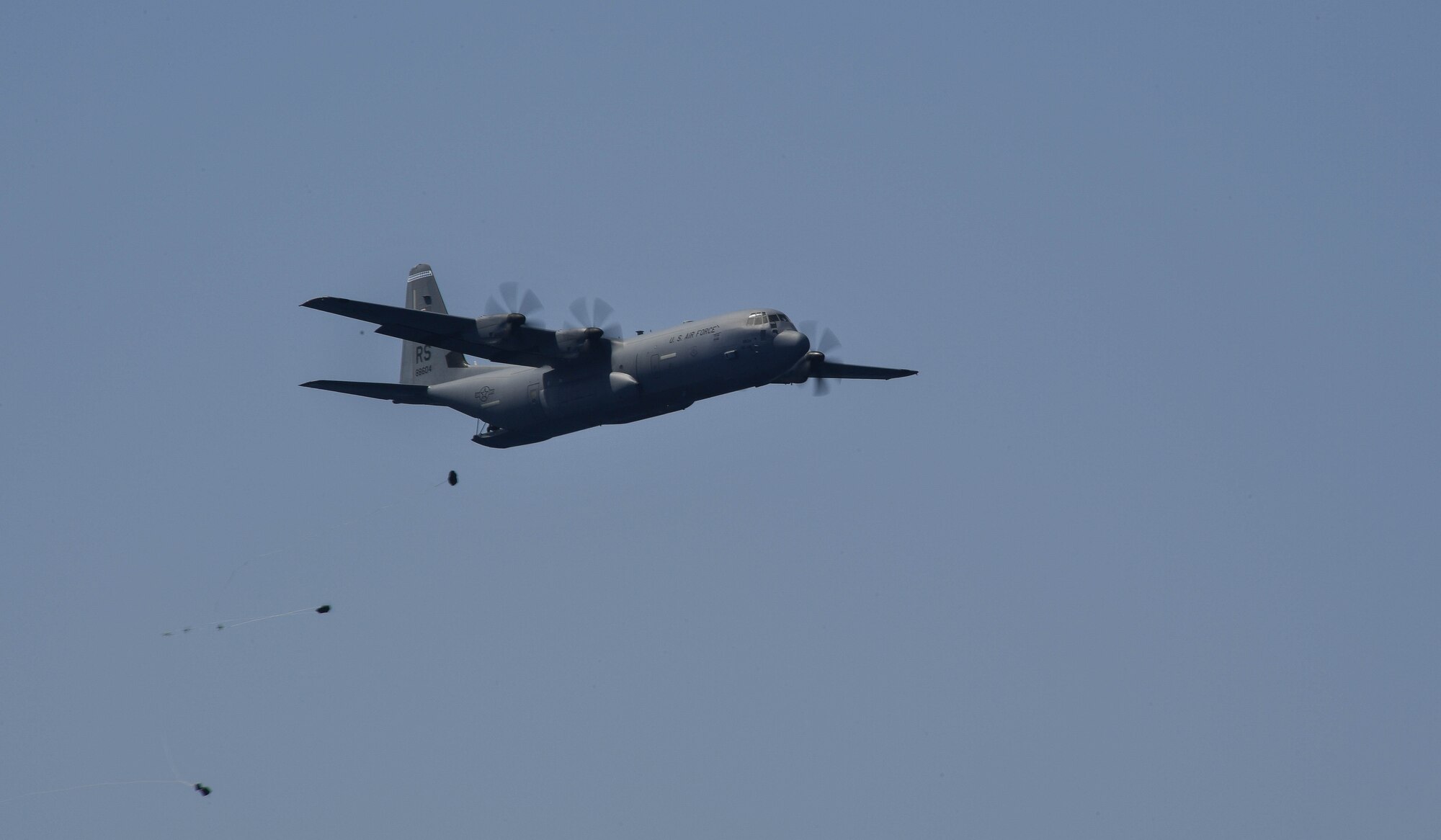 A U.S. Air Force C-130J Super Hercules drops a sea-rescue kit during Exercise Stolen Cerberus IV near Elefsis Air Base, Greece, April 27, 2017. The kit consisted of four connected duffle bags that would provide a raft, medicinal supplies, food, and water for individuals stranded at sea. Combined exercises such as these enhance the interoperability capabilities and skills among allied and partner armed forces. (U.S Air Force photo by Senior Airman Tryphena Mayhugh)