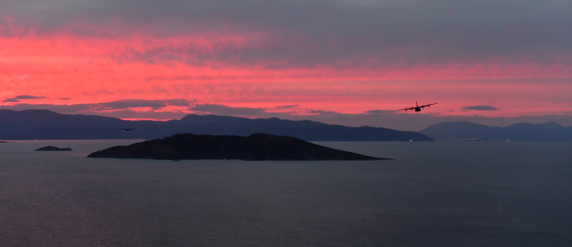 Two U.S. Air Force C-130J Super Hercules fly above the Greek coastline during Exercise Stolen Cerberus IV near Elefsis Air Base, Greece, April 19, 2017. U.S. Air Force Senior Airman Matthew Gee, 37th Airlift Squadron aircraft loadmaster, has participated throughout the exercise preparing C-130s for air drops. Approximately 110 Airmen and three C-130s from the 86th Airlift Wing’s 37th AS, Ramstein Air Base, Germany, will participate in Exercise Stolen Cerberus IV with the Hellenic air force and the U.S. Army till April 28. (U.S Air Force photo by Senior Airman Tryphena Mayhugh)