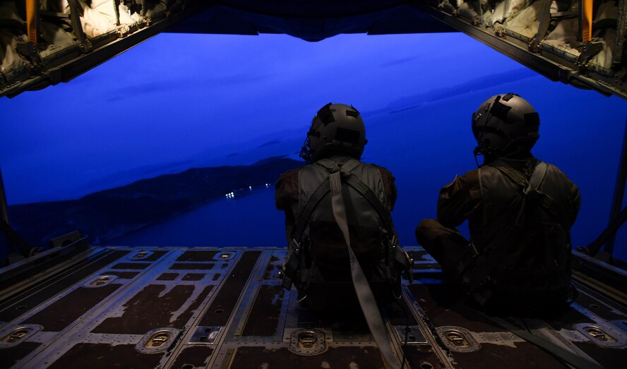 U.S. Air Force Senior Airman Matthew Gee, left, and Master Sgt. CJ Campbell, both 37th Airlift Squadron aircraft loadmasters, sit on the open ramp of a C-130J Super Hercules during Exercise Stolen Cerberus IV near Elefsis Air Base, Greece, April 19, 2017. The 37th AS loadmasters have worked with the Hellenic air force to prepare C-130s for personnel, heavy equipment, platforms, container delivering system bundles, and low-cost low-altitude bundles throughout the exercise. As NATO allies, the U.S. and Greece share a commitment to promote peace and stability, and seek opportunities to continue developing their strong relationship. (U.S Air Force photo by Senior Airman Tryphena Mayhugh)