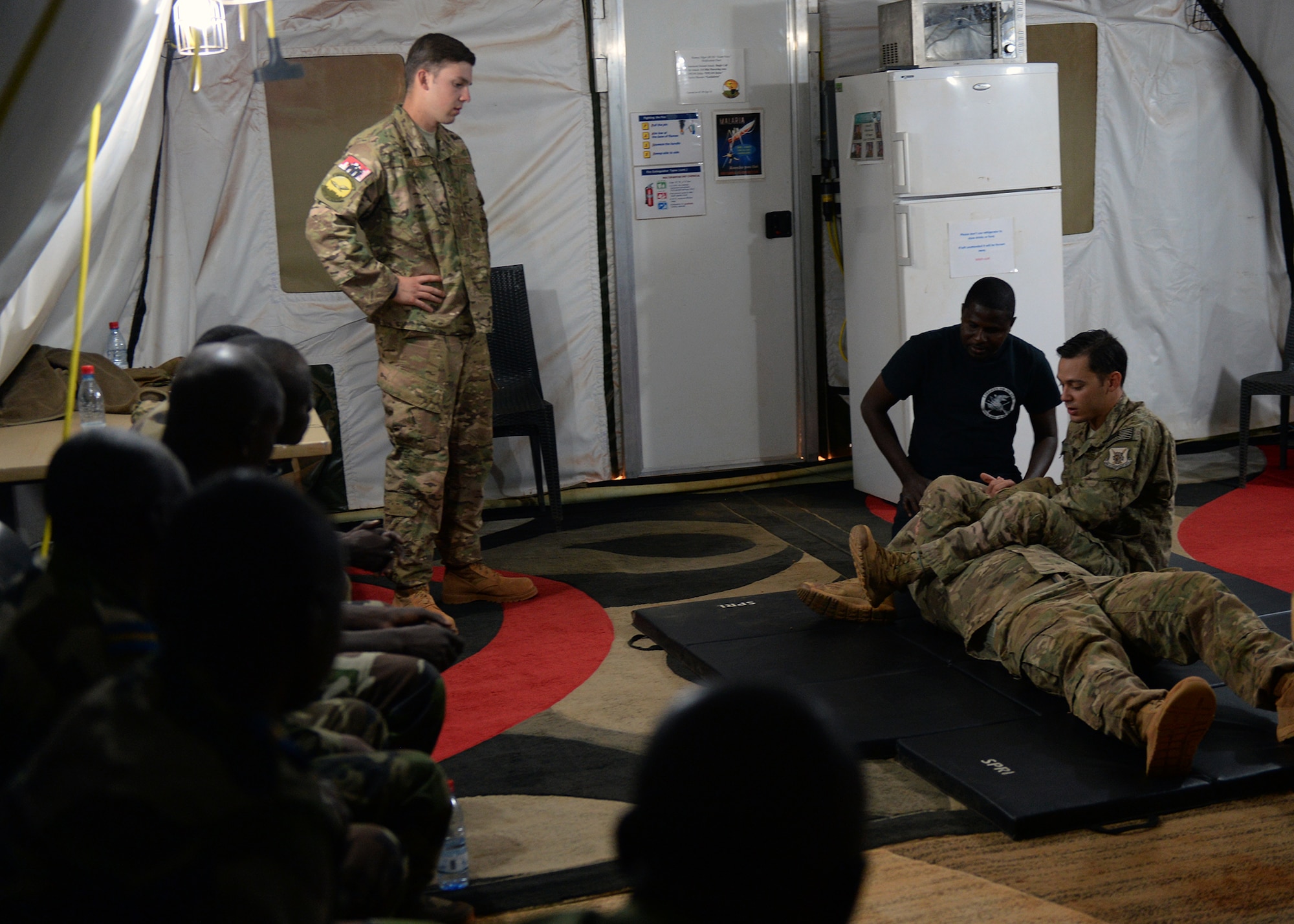 Senior Airman Joushua Brooks, 768th Expeditionary Air Base Squadron air advisor, demonstrates an armbar at Nigerien Air Base 101, Niger, April 4, 2017. The training was part of a larger joint knowledge exchange to help train and build relations with the FAN. (U.S. Air Force photo by Senior Airman Jimmie D. Pike)